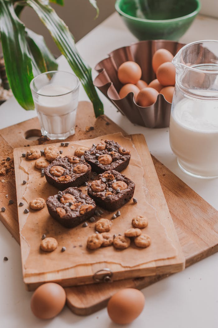 Delicious Brownies with Milk and Eggs on Wooden Board